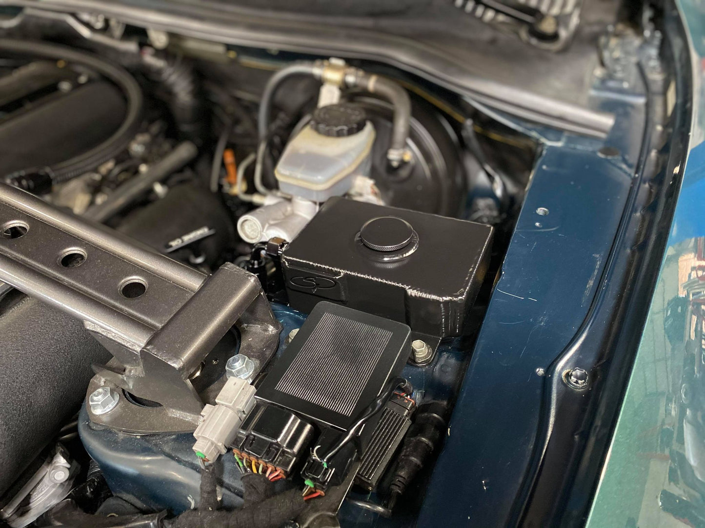 Installed in engine bay, works with factory intake and aftermarket intake manifold